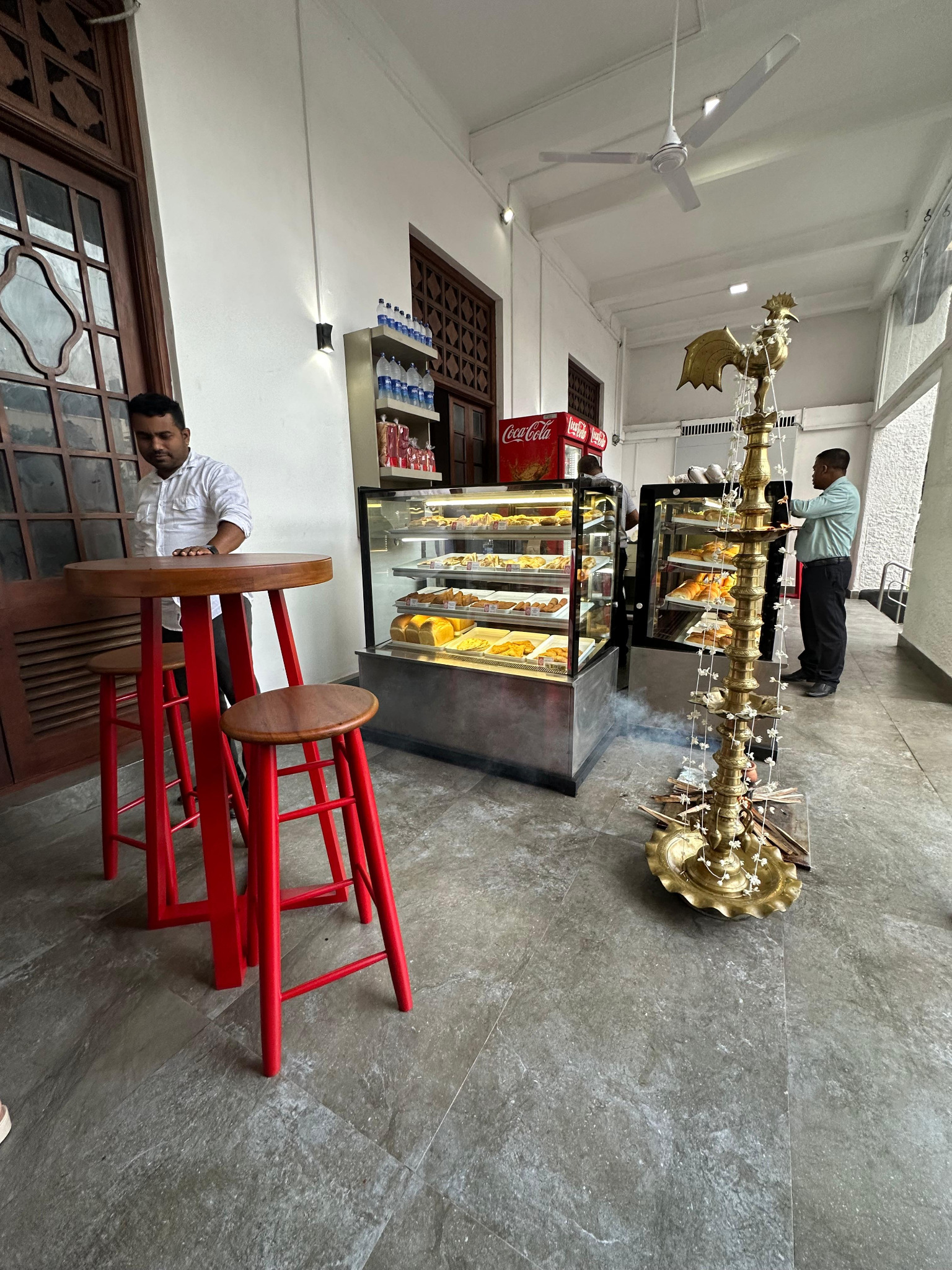 Inside BakeShop: bakery displays and red seating at the YMCA outlet
